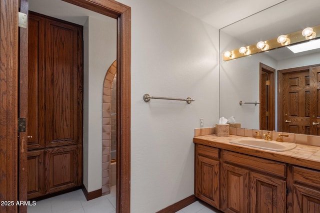 full bathroom featuring tile patterned floors, shower / bathing tub combination, baseboards, and vanity