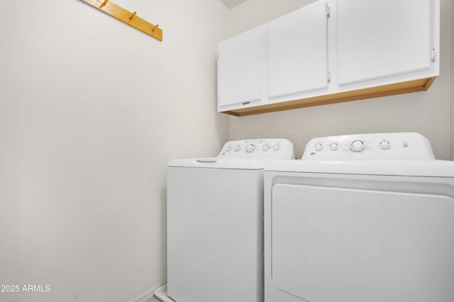 washroom featuring cabinet space and separate washer and dryer