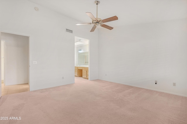 unfurnished room with visible vents, baseboards, ceiling fan, light colored carpet, and lofted ceiling