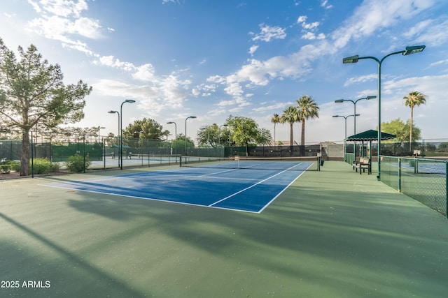 view of sport court featuring fence