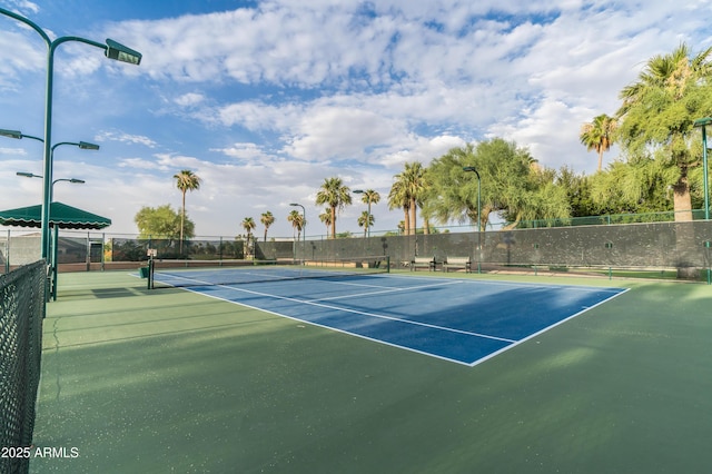 view of sport court featuring fence