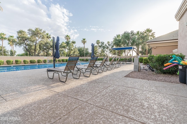 exterior space with a pool and a patio