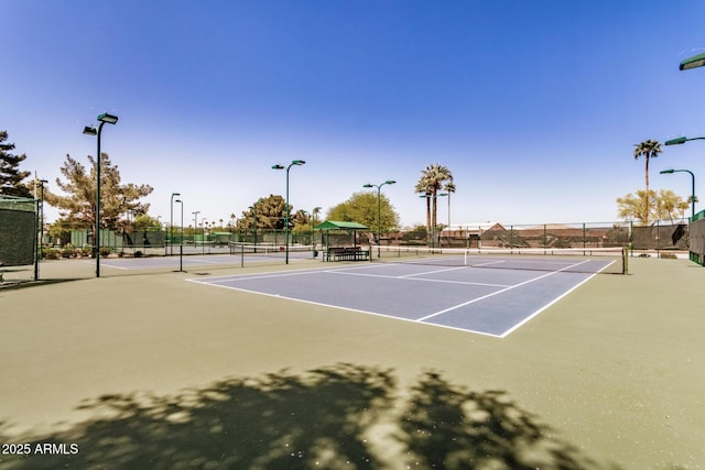view of tennis court with fence