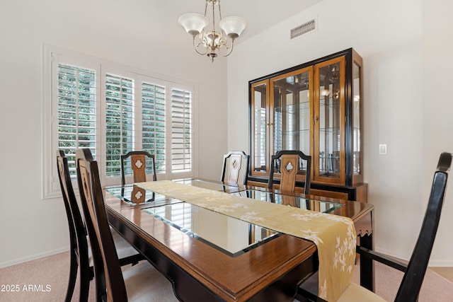 dining room with an inviting chandelier, baseboards, carpet flooring, and visible vents