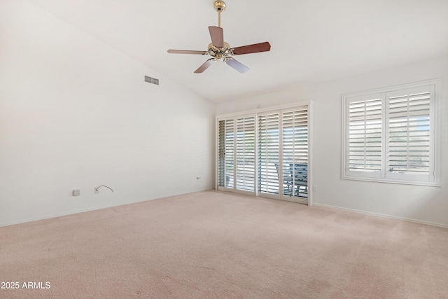 empty room with carpet flooring, visible vents, a ceiling fan, and lofted ceiling