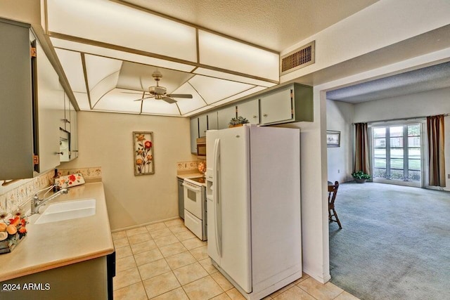 kitchen with ceiling fan, sink, a textured ceiling, white appliances, and light tile patterned floors