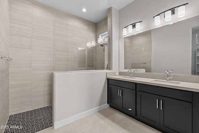 full bathroom featuring a walk in shower, double vanity, a sink, and tile patterned floors