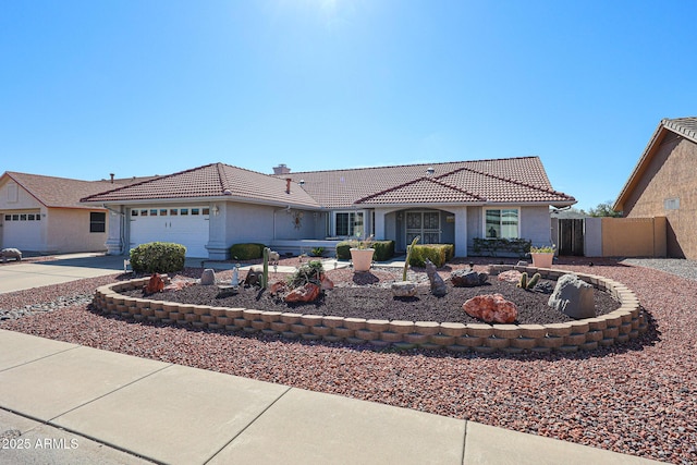 view of front of property with an attached garage, a tiled roof, concrete driveway, and stucco siding