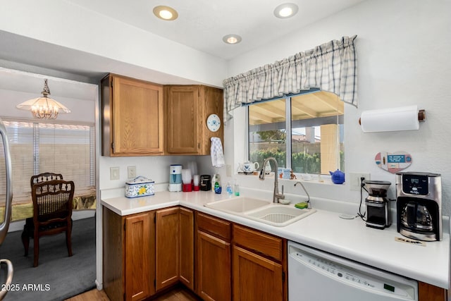 kitchen with an inviting chandelier, decorative light fixtures, dishwasher, and sink