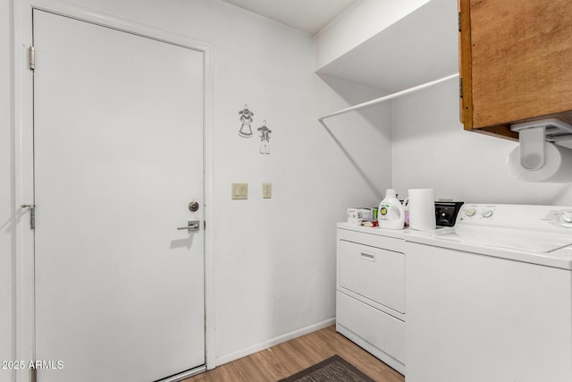 laundry area featuring washer and dryer and light wood-type flooring