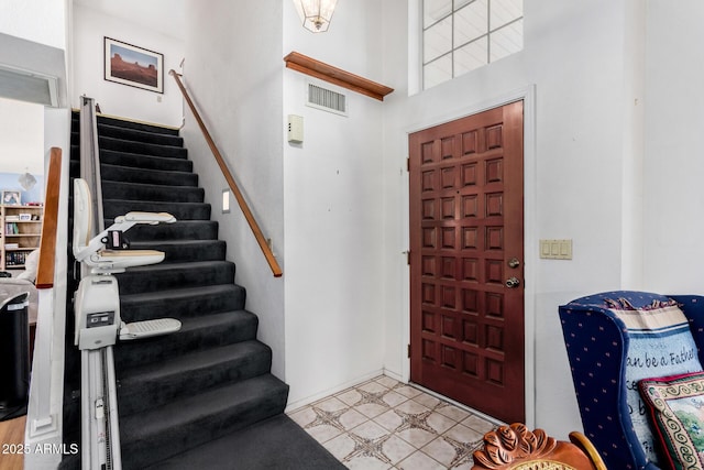 foyer featuring a high ceiling and light tile patterned flooring