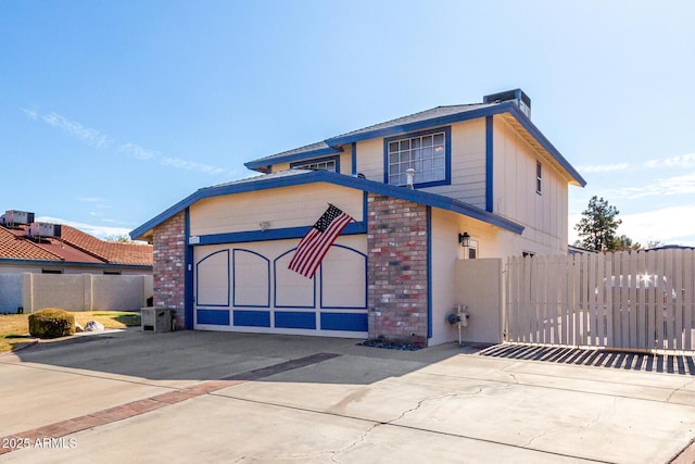 view of front of property with a garage and central AC unit