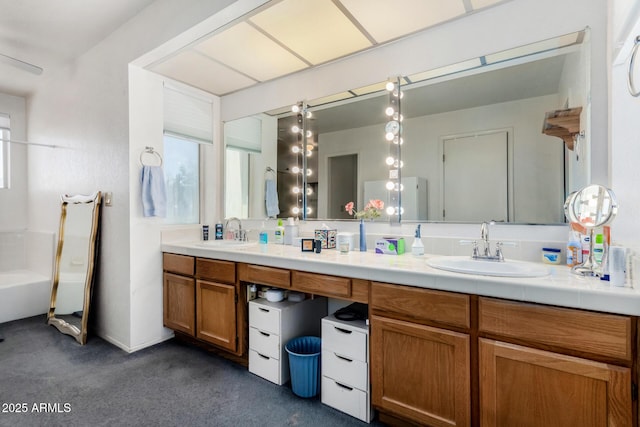 bathroom featuring vanity and a tub