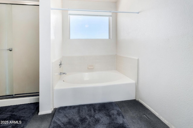 bathroom with a tub to relax in