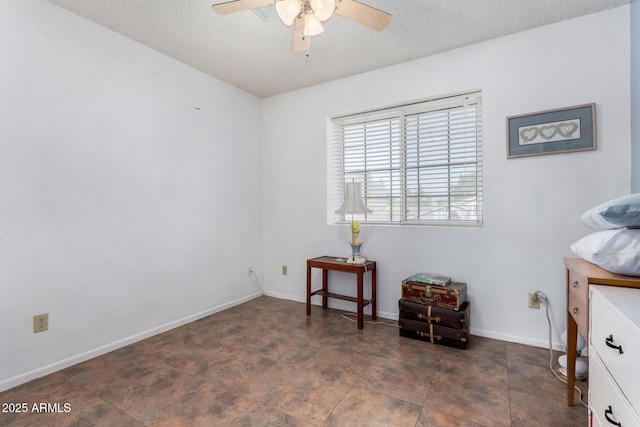 interior space with a textured ceiling and ceiling fan