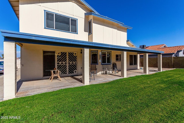 back of house featuring a yard and a patio