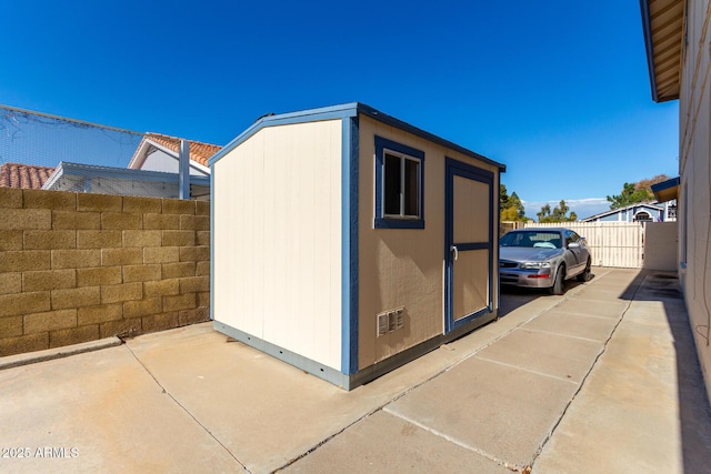 view of home's exterior featuring a storage shed and a patio area