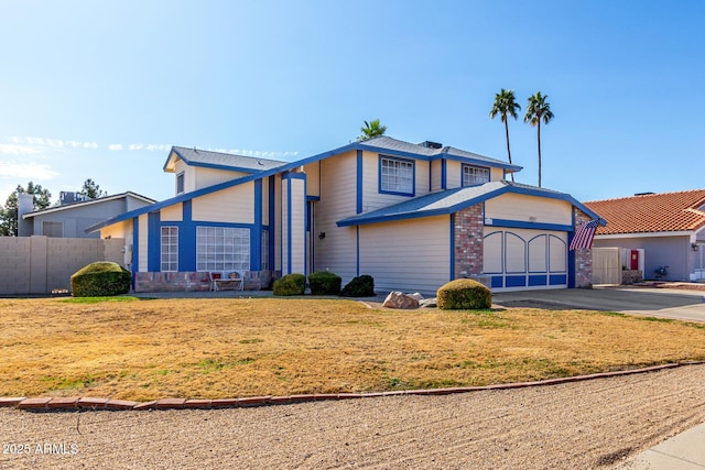 front facade featuring a garage and a front lawn