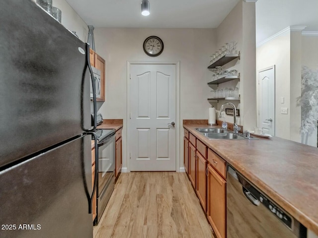 kitchen featuring open shelves, brown cabinetry, a sink, light wood-type flooring, and black appliances