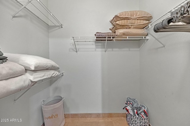 spacious closet featuring light tile patterned flooring