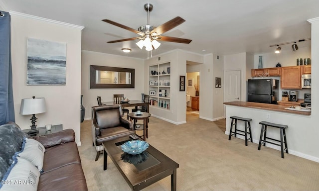 living room with built in features, light colored carpet, ornamental molding, and baseboards