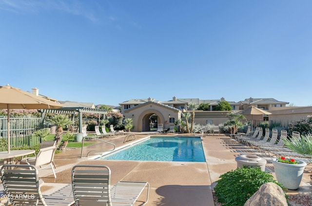 pool with a patio area, fence, and a pergola