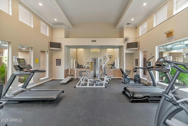 exercise room with recessed lighting, visible vents, and baseboards