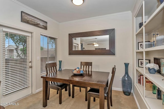 dining space featuring ornamental molding, light carpet, baseboards, and built in shelves