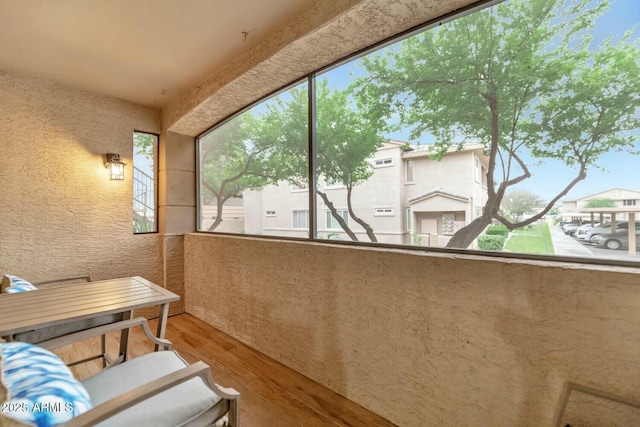 sunroom featuring plenty of natural light and a residential view