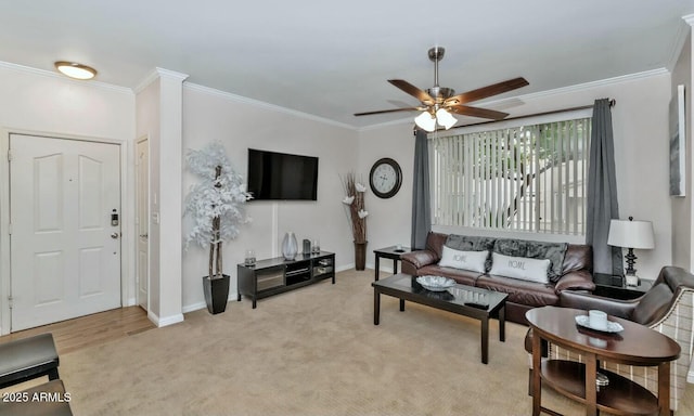 living room with baseboards, ornamental molding, a ceiling fan, and light colored carpet