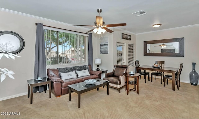 living area with visible vents, crown molding, light carpet, and baseboards