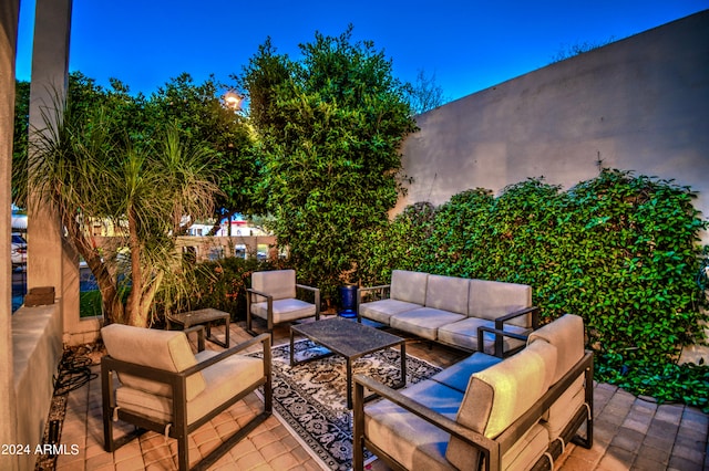 patio at night featuring an outdoor living space