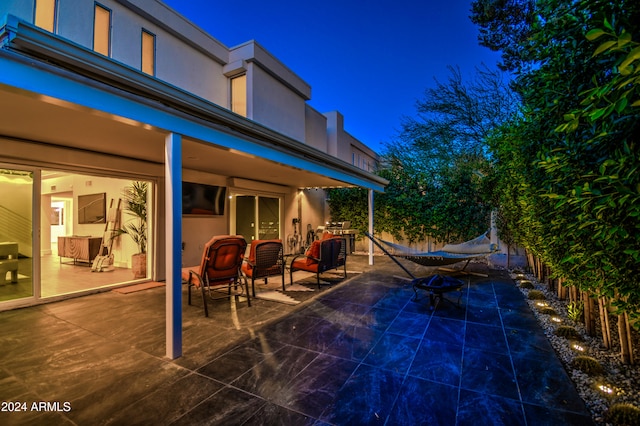 pool at night with a patio area