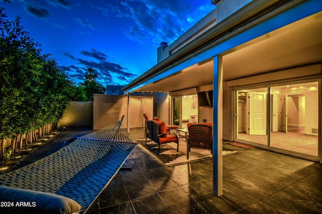 view of patio terrace at dusk