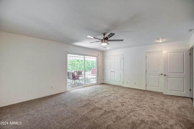 interior space with carpet flooring and ceiling fan