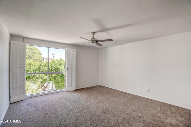 empty room with ceiling fan and carpet floors