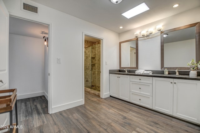 bathroom with an enclosed shower, hardwood / wood-style flooring, and vanity