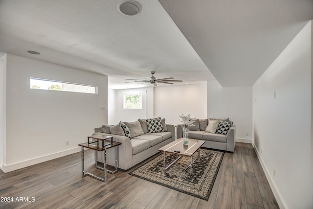 living room featuring a healthy amount of sunlight, ceiling fan, and dark hardwood / wood-style floors