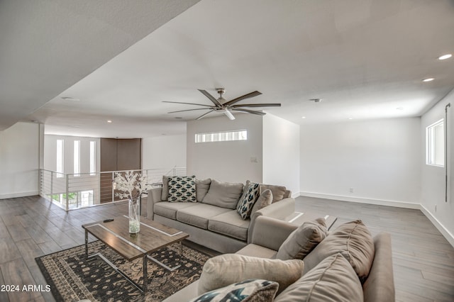 living room featuring light hardwood / wood-style flooring and ceiling fan