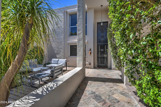 doorway to property featuring an outdoor hangout area and a patio