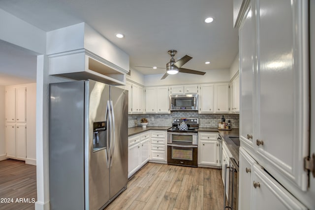 kitchen with light wood-type flooring, white cabinetry, ceiling fan, decorative backsplash, and appliances with stainless steel finishes