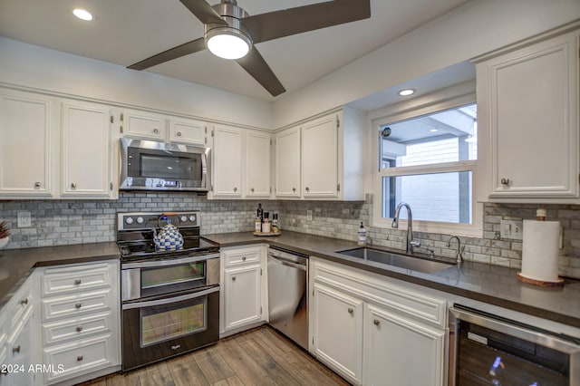 kitchen with white cabinets, ceiling fan, stainless steel appliances, and wine cooler