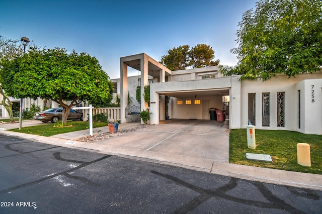 modern home with a front lawn and a carport