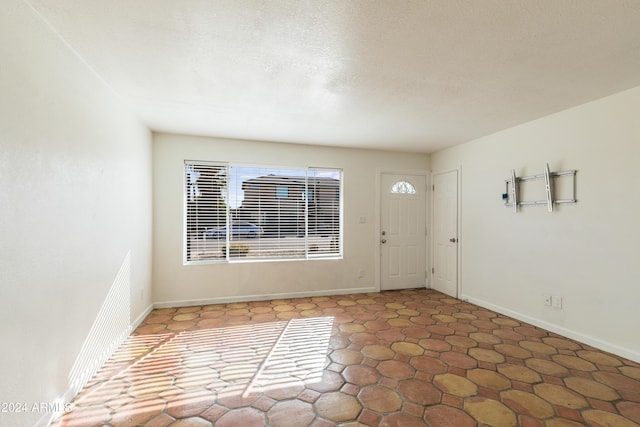 foyer entrance with a textured ceiling