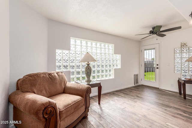 sitting room featuring hardwood / wood-style flooring and ceiling fan