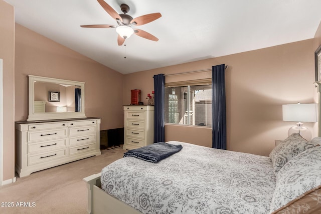 bedroom featuring ceiling fan, vaulted ceiling, and light carpet