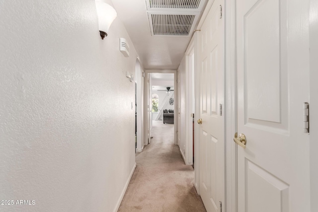 hallway with light colored carpet