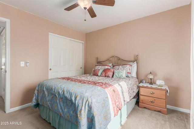 carpeted bedroom with ceiling fan and a closet