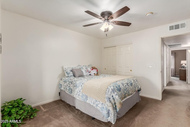 carpeted bedroom with ceiling fan and a closet