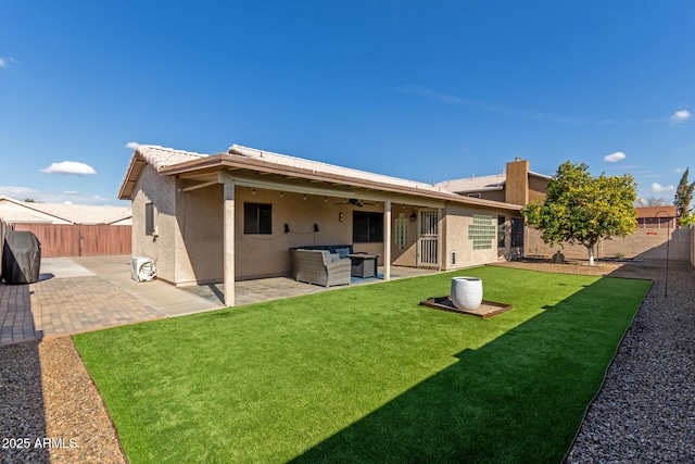 back of house with a yard, outdoor lounge area, and a patio